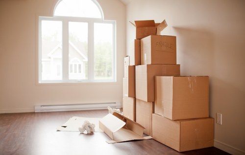 A family loading packed boxes into a moving truck